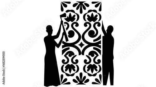 Silhouette of two figures installing a decorative panel with floral and scrollwork design in black and white