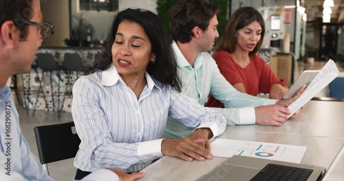 Middle-aged 55s Indian woman shaking hands, finalizing negotiations successfully