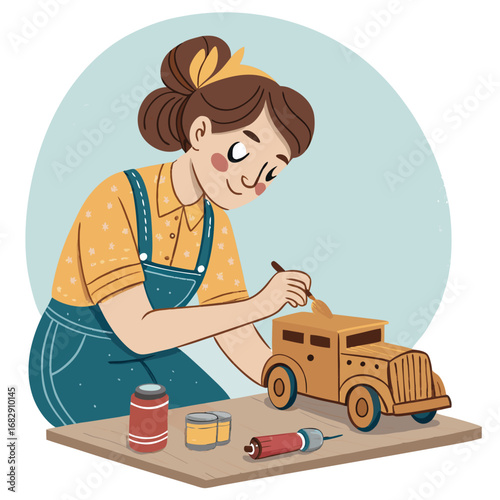 A young woman carefully paints a wooden model car.