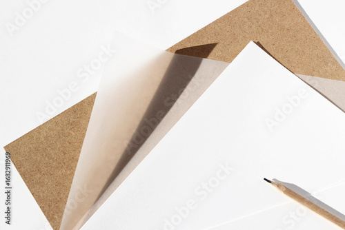 Paper Sheets, Tracing Paper, Cardboard, Pencil on White Desk. Designer Work.