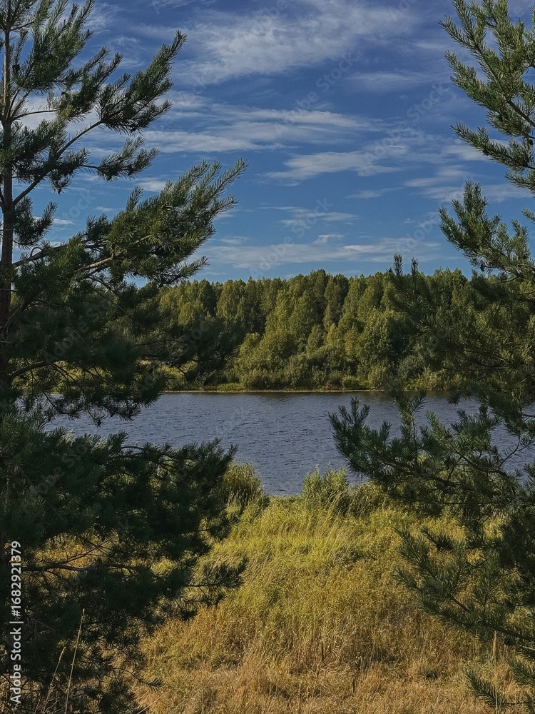 Obraz premium Tranquil Lake Surrounded by Lush Greenery