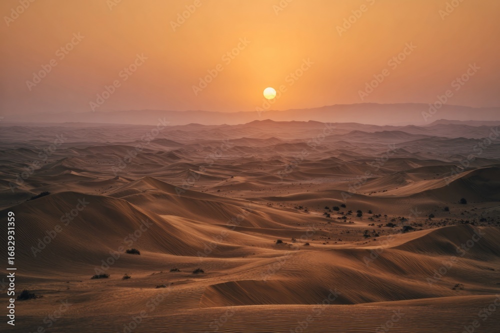 Fototapeta premium Wide desert landscape with glowing sun setting behind distant dunes, warm golden orange gradient sky