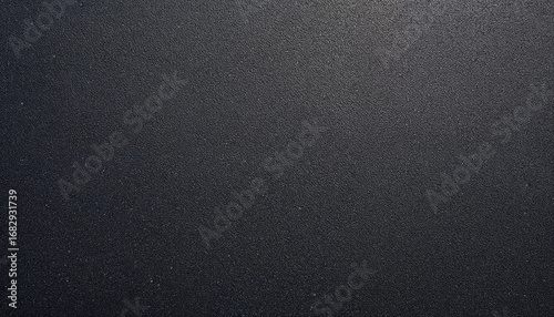 Top-down close-up of freshly laid asphalt with smooth dark surface
