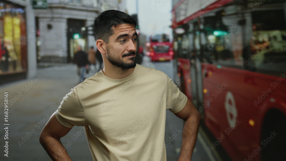 Fototapeta premium Young man standing confidently in an urban street with a background of iconic red buses, showcasing a charming smile and relaxed posture in a cosmopolitan city scene