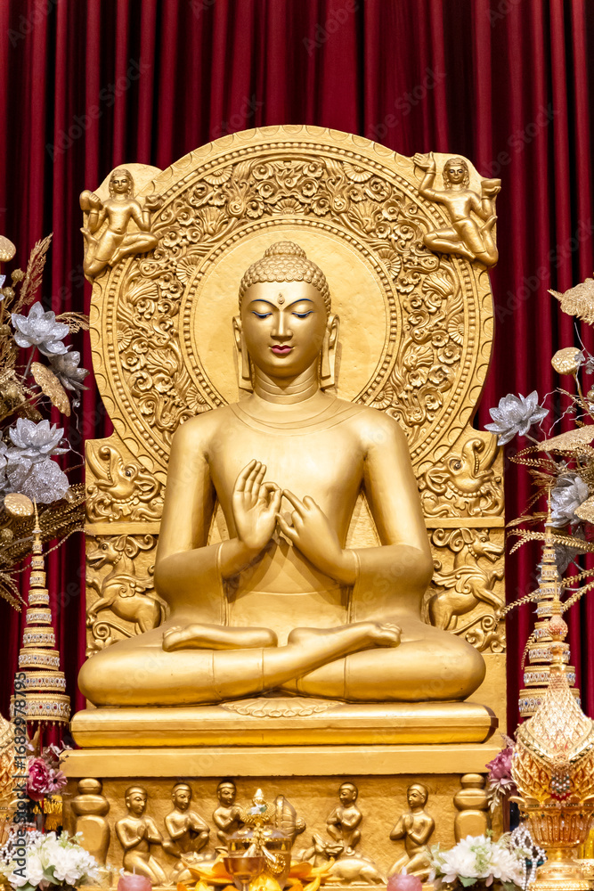 Fototapeta premium holy golden buddha sculpture in monastery interior