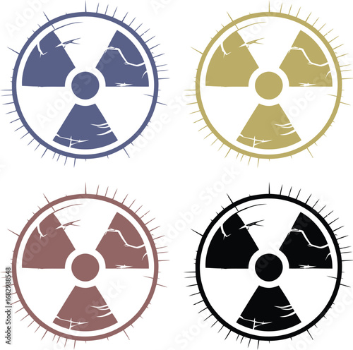 Four grunge radiation symbols in different colors on white background