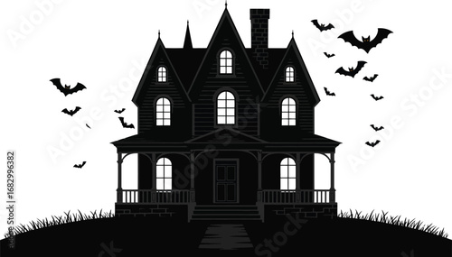 Spooky victorian haunted house silhouette with flying bats at night