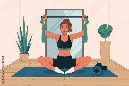 Woman doing seated stretch with resistance band in front of mirror in a bright and airy room space