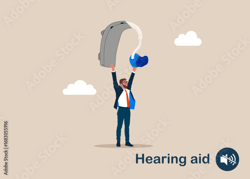 Businessman holding hearing aid for the hearing impaired and the deaf. World Deaf Day in last Sunday of September. Hearing aid device electrically stimulates nerve medical aid. 
