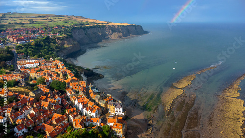 Rainbow above coastal rooftops in Robin Hood’s Bay England