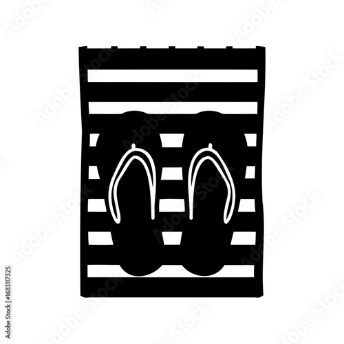 Flip flops on a striped surface convey relaxed vacation vibes and monochrome style