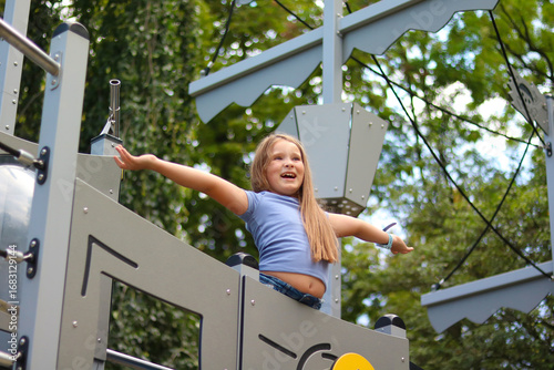 Joyful girl playing on a playground