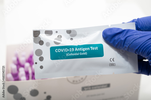 Принти на полотні Doctor holding COVID 19 Antigen Test - Colloidal Gold - with swabs in the backgr