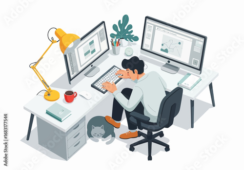 A man working on computer with a cat resting at his feet, work from home setup 