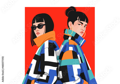 Two fashionable women posing in vibrant, colorful jackets against a bold red backdrop. They are styled with sunglasses, hoop earrings, and a bun, showing modern trend and style