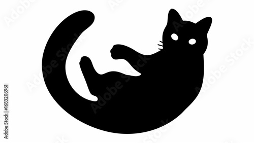 Silhouette of a black cat lying on its back with its tail curled around and paws up in the air looking playful
