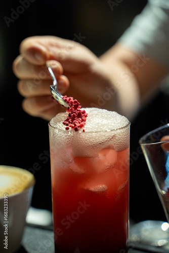 Raspberry Cocktail Served by Bartender’s Hand and decor.