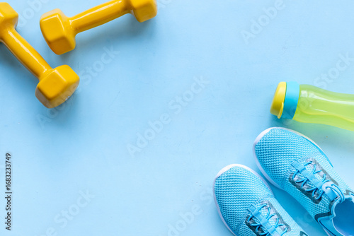 Sport fitness tolls flat lay with sneakers and dumbbells, top view