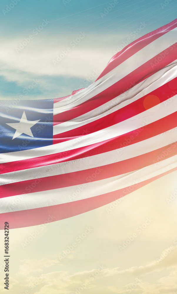 Obraz premium Liberia flag waving light background hidden in the sky.
