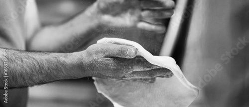 Chef's hands spraying flour over the dough. Kneading dough. chef kitchen dough