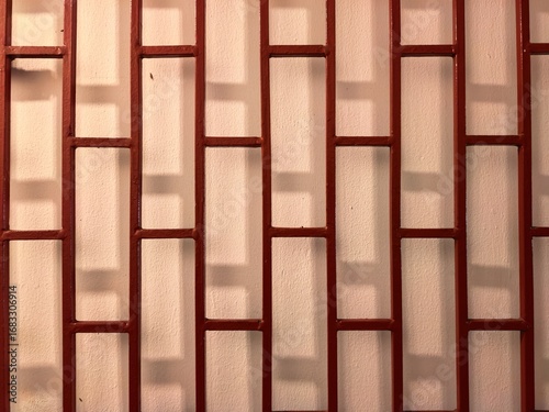 Red metal bars against a white wall