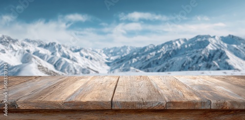 Wooden tabletop with a snowy mountain backdrop
