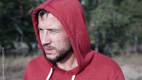 Portrait of a man after jogging in the park. The guy does sports to get rid of depression and alcohol addiction.