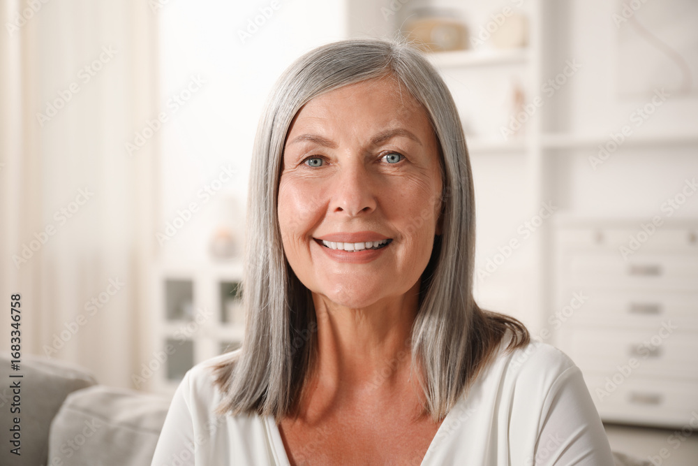 Fototapeta premium Elegant senior woman on sofa at home
