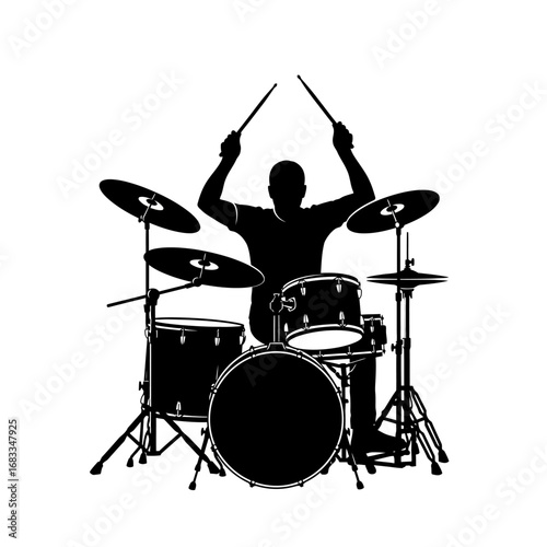 Silhouette of a drummer playing a drum kit.