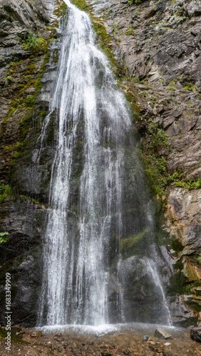 Aerial view of Sutovsky waterfall cascading through lush forest in Mala Fatra National Park, Slovakia. Majestic nature scene in Europe, perfect for travel, documentary and environmental projects