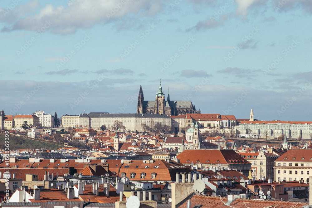 Fototapeta premium Stunning panoramic shot of Prague Castle set against the sky, overlooking traditional rooftops, showcasing the beauty of Czech architecture.