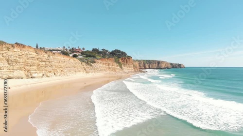 Stunning Algarve Portugal beach coastline scenic ocean waves sand dunes sun sky houses cliffside summer vacation paradise