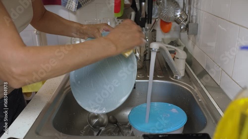 Woman washing dishes