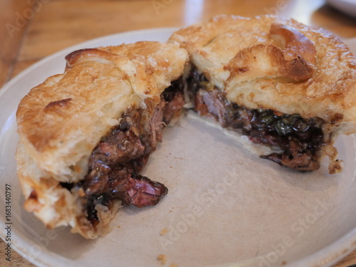 Golden Shepherd's Pie with rich meat filling and flaky crust, served on white plate at Sheffield Pie Shop, South Island, New Zealand.