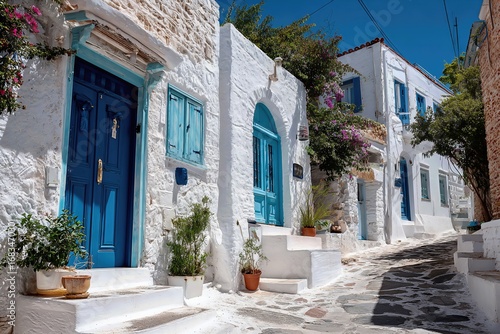 Fototapeta Naklejka Na Ścianę i Meble -  Greek island street with white houses and blue doors wallpaper