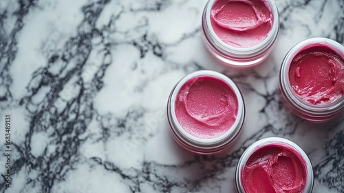 Pink Lip Balm Jars On Marble Surface