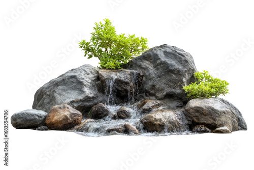 Miniature waterfall cascading over rocks with greenery (1)