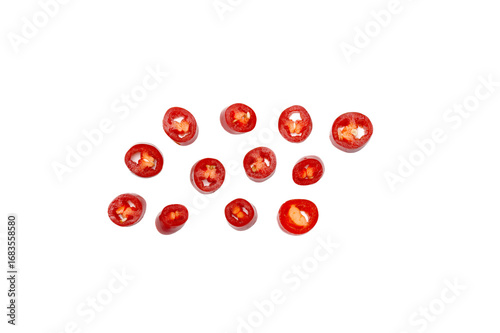 Tapeta Sliced red chili rounds scattered on white background