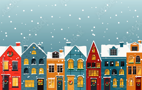 A charming winter scene with colorful houses covered in snow, creating a cozy and festive atmosphere.