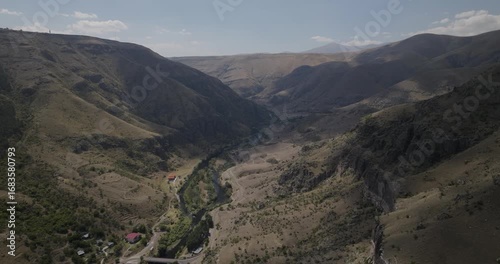 Aerial view of winding rivers through rugged mountains, carving pathways through the landscape, creating a tapestry of textures and tones, Gogasheni, Samtskhe-Javakheti, Georgia.
