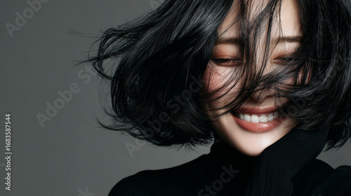 An elegant female with glossy beautiful black medium bob hair. Best use for advertisement for hair salon,  hair care and beauty products such as shampoo and treatment.