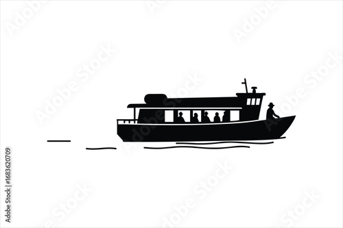 Silhouette of a passenger ferry boat with people visible inside sailing on the water