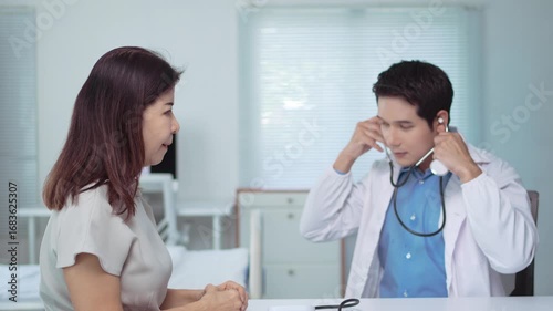 Wallpaper Mural Experienced asian doctor conducting health checkup, auscultating patient's chest using stethoscope in modern medical office environment Torontodigital.ca