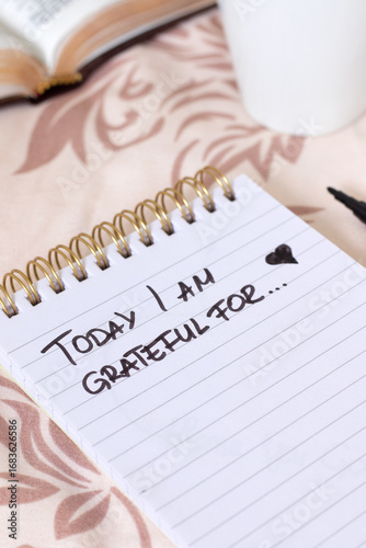 Today I am grateful for, handwritten text in notebook with holy bible and cup of coffee. Close-up. Christian gratitude and thanksgiving journal, biblical concept.