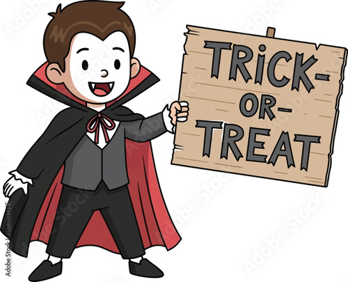 Smiling young boy dressed as a vampire holding a trick or treat sign for halloween