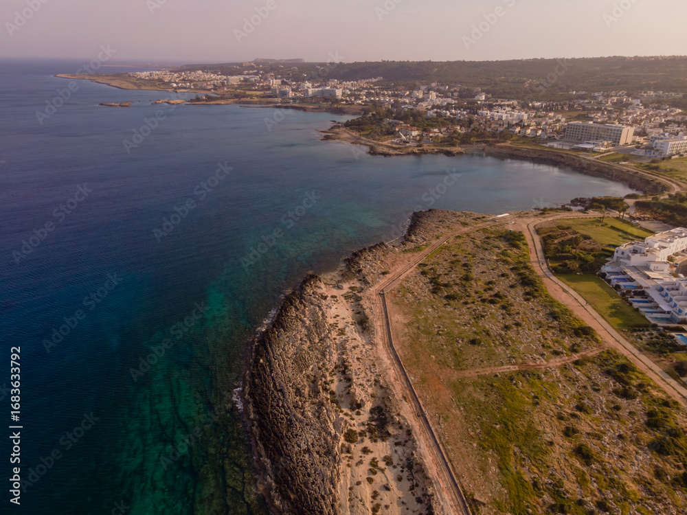 Fototapeta premium Aerial View of Cyprus Coastline with Cliffs, Beach, and Turquoise Sea