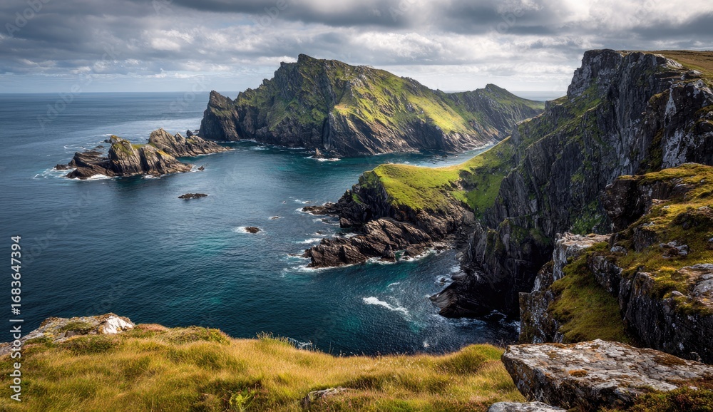 Fototapeta premium Dramatic coastal scenery with rugged cliffs, lush green hills, and a turquoise-tinged ocean