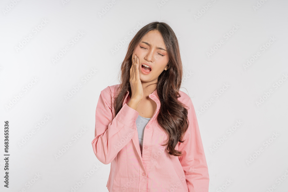 A woman endures severe pain and distress from a toothache, highlighting her struggle A woman endures severe pain and distress from a toothache, highlighting her struggle