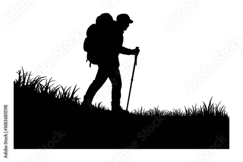 Silhouette of a hiker with a backpack and trekking pole walking uphill through grass field