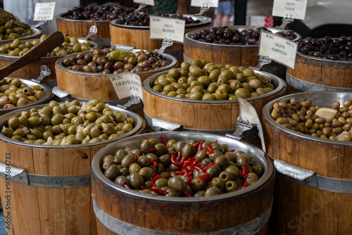 Pickled and marinated black and green olives, artichokes, vegetables on French farmers market, variety of tasty tapas